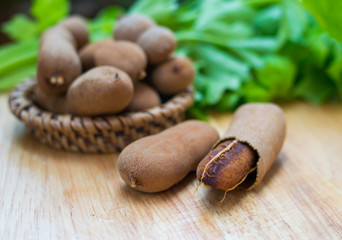  tamarind fruit on wooden background