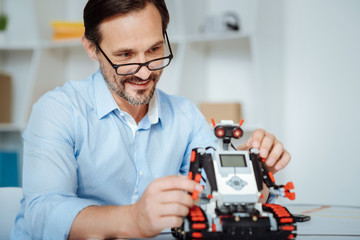 Positive engineer inspecting functions of robot