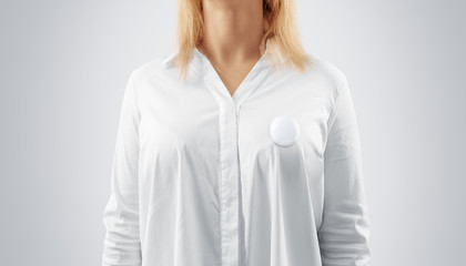 Blank button badge mockup pinned on the womans chest. Girl wear white shirt and campaign pin mock up. Volunteer round emblem design element. Pesron stand front view with canvass voting symbol template