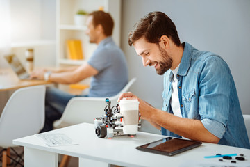 Positive engineer testing the robot