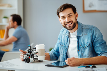 Positive professional engineer testing robot