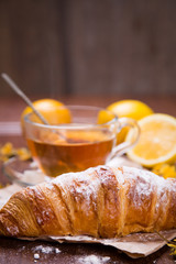 fresh hot tea with croissant