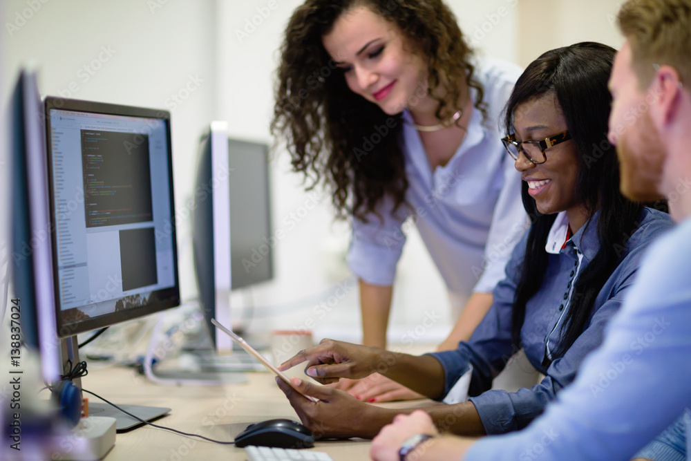 Wall mural programmers cooperating at information technology company