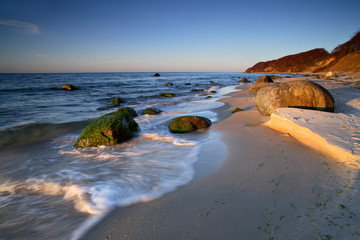 Huge Boulders on Sand Beach in the Warm Light of the Setting Sun, Waves rolling in, Baltic Sea, Rugen Island, Germany