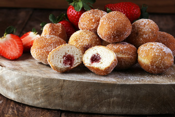 Bomboloni - traditional Italian doughnuts stuffed with strawberry jam
