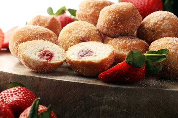 Bomboloni - traditional Italian doughnuts stuffed with strawberry jam