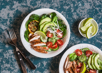 Roasted chicken, avocado and fresh vegetable salad. Healthy food concept