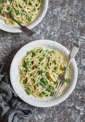 Creamy green pea spaghetti. On wooden background, top view