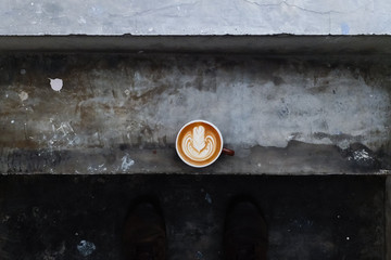 Coffee cup with latte art on the stairs