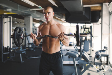 Fototapeta na wymiar Handsome man working out in gym