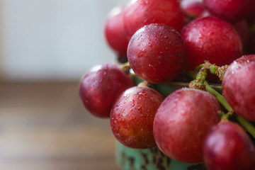 Close view of grapes in ceramic bowl.