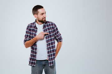 Smiling Bearded man in shirt pointing away