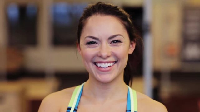 happy smiling young woman at gym