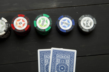 Playing poker on black wooden table