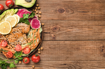 Fish with mixed vegetable and avocado .