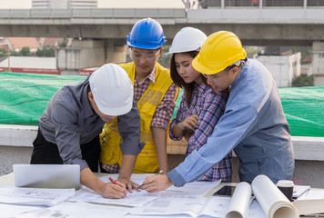 business people group on meeting and presentation with construction engineer architect and worker looking building model and blueprint plans