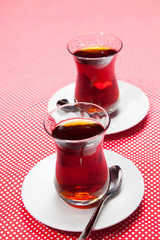 Two cups of tea on a red background