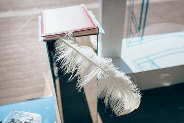 Feather wedding decoration in notebook. Outdoor, no people