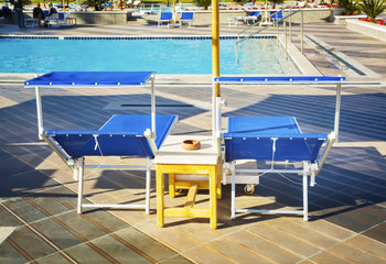Blue sun chair on the background of  swimming pool
