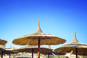 Sunshades in the blue sky in Hurghada background
