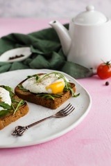 Toast with poached Egg and arugula (close-up)