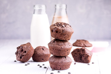 Chocolate muffin with two bottle of milk Chocolate milk Wooden background