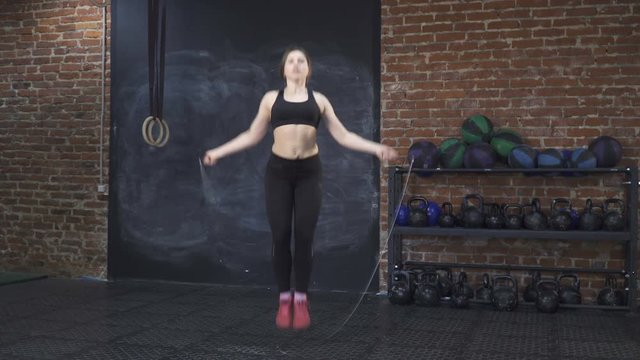 Fitness woman doing double jumping rope in the gym