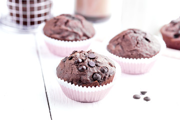 Chocolate muffins with chocolate drops Copy space Wooden background