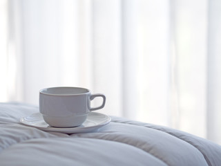 Fototapeta na wymiar Fresh morning coffee on the bed.