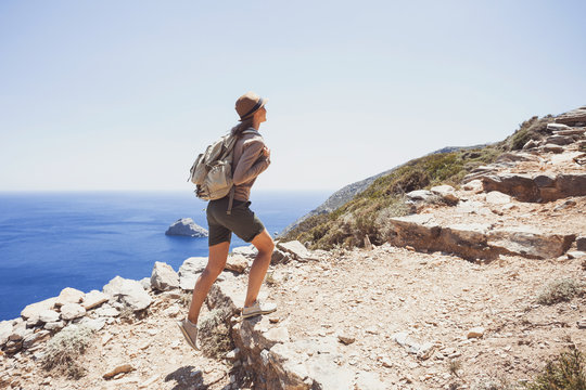 Hiker traveler woman on a hiking trail, travel and active lifestyle concept