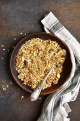 Homemade delicious granola in a clay bowl .Top view with space for text.