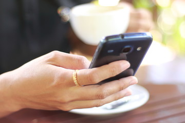 Close up photo of hand using mobile smartphone.