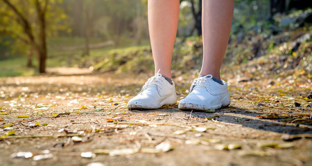 White shoes on the ground with soft light.