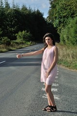 Woman making hitchhiking in the countryside