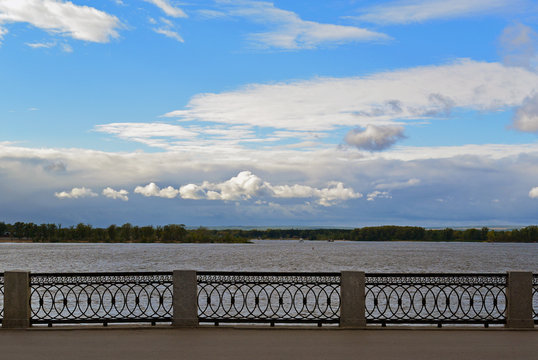 Front view on the Volga quay of the Samara city in anticipation of thunderstorm. City embankment, beautiful sky with cumulus clouds before rain at cloudy autumn day