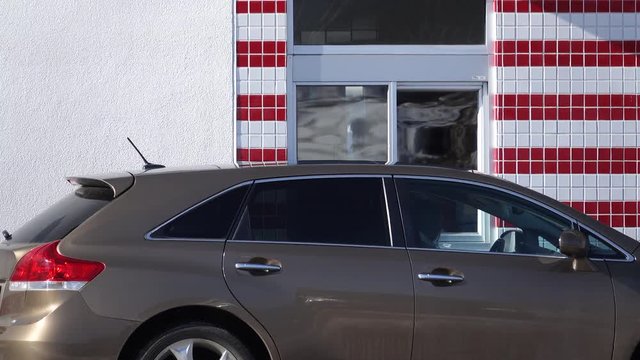 A car pulling up to a fast food window