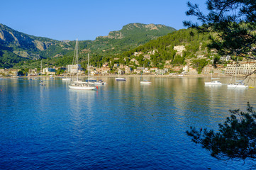 Boats moored in the evening sun in the bay at Port De Soller Majorca Spain