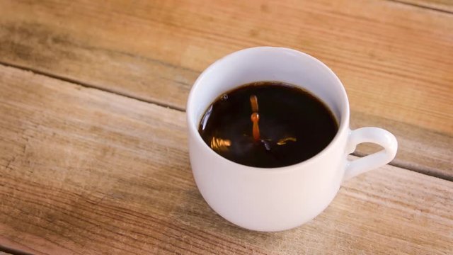 Seamless loop - Drop falling in a cup of coffee, HD video