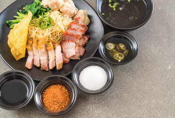 Egg noodle with red roast pork, crispy pork, dumplings and soup