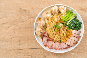 Egg noodle with red roast pork, crispy pork, dumplings and soup