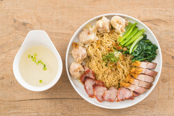 Egg noodle with red roast pork, crispy pork, dumplings and soup