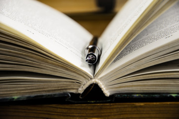 Open book and fountain pen