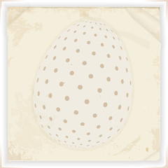 Withe decorated Easter egg over vintage paper background