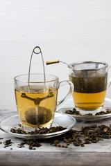 Green tea. Strainer. Grey wooden background. Copy space