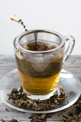 Green tea. Strainer. Grey wooden background. Copy space