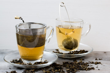 Green tea. Strainer. Grey wooden background. Copy space