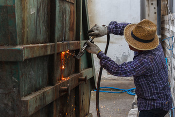 welder worker with cutting torch