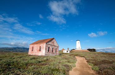 Fototapeta na wymiar Piedras Blancas lighthouse and redbrick fog signal building on the Central California Coast north of San Simeon California USA