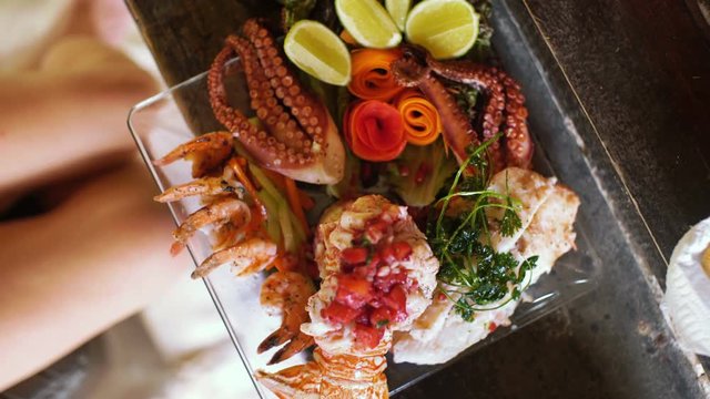 elaborate seafood platter being served at outdoor restaurant