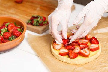 decorating fresh strawberry tart